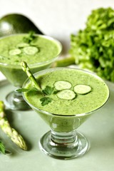 soup puree from avocado, asparagus and cucumber. Dietary detox diet. Vegetarian dish. serving soup in a glass bowl.