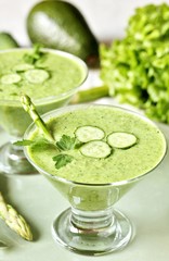 soup puree from avocado, asparagus and cucumber. Dietary detox diet. Vegetarian dish. serving soup in a glass bowl.