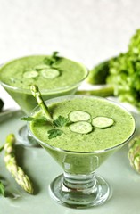 soup puree from avocado, asparagus and cucumber. Dietary detox diet. Vegetarian dish. serving soup in a glass bowl.