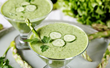 soup puree from avocado, asparagus and cucumber. Dietary detox diet. Vegetarian dish. serving soup in a glass bowl.