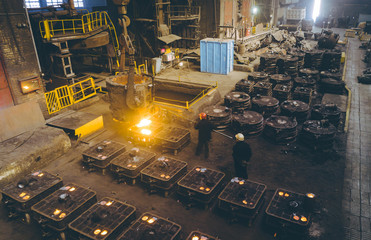 Worker controlling metal melting in furnaces