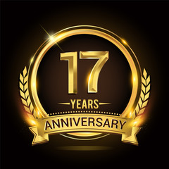 Celebrating 17th years anniversary logo with golden ring and ribbon, laurel wreath vector design.