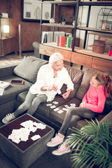 Obraz premium Preschool girl studying letters with her caring granny