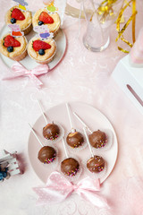 Fototapeta na wymiar Chocolate lollipop on pink background