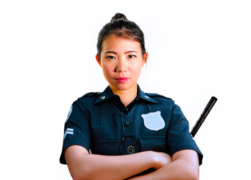 young attractive and defiant Asian Chinese police officer in uniform holding defense stick serious isolated on white background in law enforcement occupation