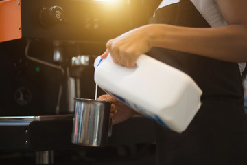 Coffee maker with staff being used. Employees working with coffee makers.