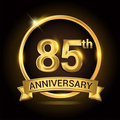 85th golden anniversary logo, with shiny ring and ribbon, laurel wreath isolated on black background, vector design