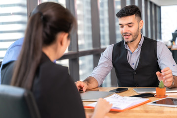 Businesspeople discussing together in conference room during meeting at office.