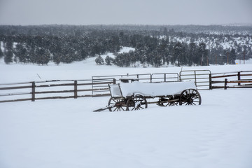 wagon with snow piled up in a winter landscape 