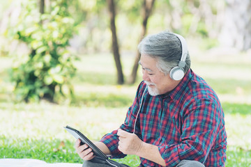 Lifestyle senior man feel happy enjoy listening to music with earphones headphones isolated on white background