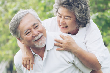 Fototapeta premium Happy love Elderly couple smile face , Senior couple old man and senior woman relaxing hug in a forest