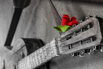 old guitar on concrete wall background with blurred front and back background with bokeh effect