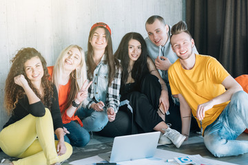 Solid business team. Work and relax together. Diverse youth group sitting on floor. Casual atmosphere for ambitious goal.