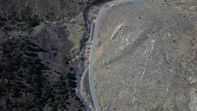 Cinematic Drone Aerial Bird View Footage of Road With Cars by Clear Creek River Beetween Ricky Hills of Lookout Mountain Denver Colorado 4k