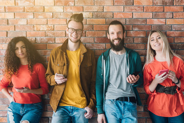 Always connected. Social networking. Group of millennials with smartphones surfing, chatting. Digital communication.