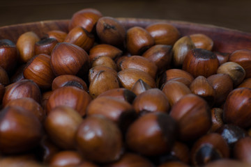 hazelnuts scattered on boards, photographed from above, forming a uniform background