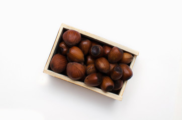 hazelnut in a wooden box on white background, with a place for the text 