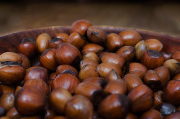 hazelnuts scattered on boards, photographed from above, forming a uniform background