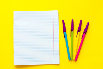 Back to school concept with space for text. Top view. Copy space. School office supplies.Creative desk with colourful stationery. Colored paper clip.School supplies on yellow background.Office desk.