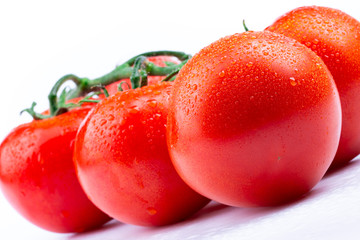 fresh red tomatoes on white background