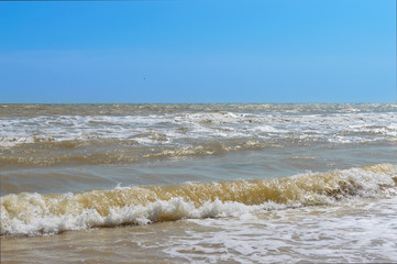 Waves on the shore. Sea wave with sunlight. Beautiful view of the sea and blue sky. Seascape.