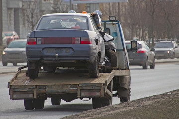 Fototapeta na wymiar tow truck, takes away the damaged car after an accident