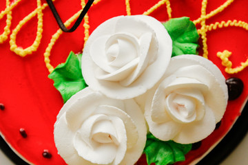 Happy birthday cake  on white background.Romantic love background. Birthday party decorated cake. Delicious red cake with white cream roses.