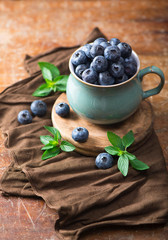 blueberry in a cup on a wooden background