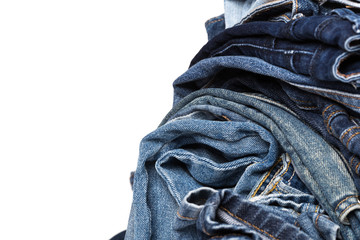 stack of various shades of blue jeans