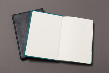 top view of a open notebook with pencil on a gray background