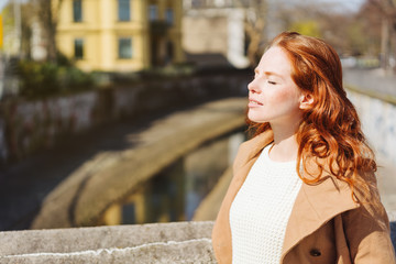 Elegant young woman in a stylish overcoat
