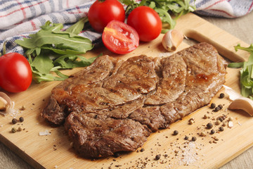 A beef steak well done with vegetables