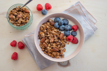 Healthy breakfast super food cereal concept with fresh fruit, granola, yoghurt