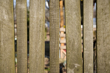 Closeup of an old retro vintage fence of aged wooden texture without paint. Old fence in the countryside.