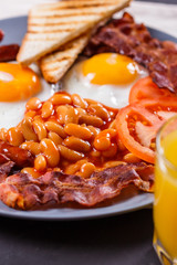 delicious English breakfast on a dark rustic background