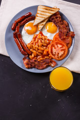 delicious English breakfast on a dark rustic background