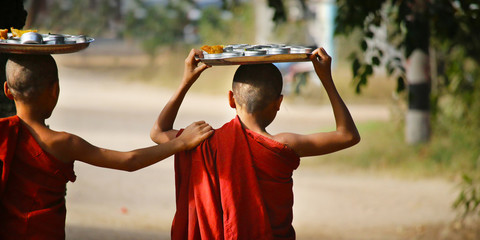 Novice monks recept  alms in the historical park of Bagan,Myanmar