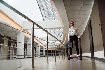 Young businessman is riding a gyroboard 