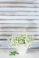 White flowers bouquet against wooden shutters