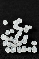 lose up picture of polypropylene granules on a dark background, selective focus.