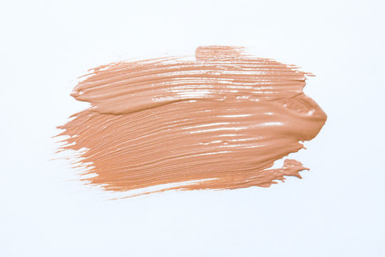 Liquid foundation smudges isolated on white background. Light  tone foundation texture for background. BB, CC cream foundation. Make-up base foundation.Professional makeup products. Top view.