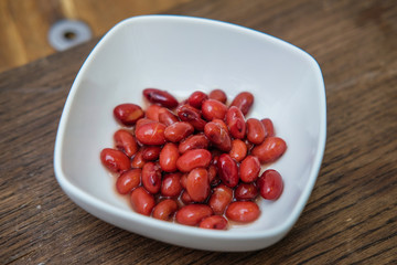 Grits in a white Cup on a cutting Board