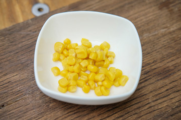 Grits in a white Cup on a cutting Board