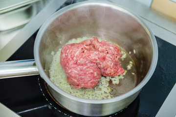 Meat cutlet in the pan.