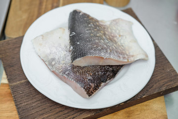Cleaned raw fish on the plate.