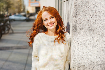 Relaxed confident young redhead woman