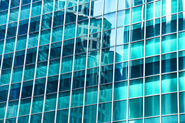 Fototapeta na wymiar High glass skyscrapers on the streets of Singapore. Office windows close up