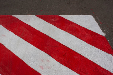 Texture. Painted on asphalt red white sign for special vehicles. Place for fire services and rescuers, emergency. No parking zone
