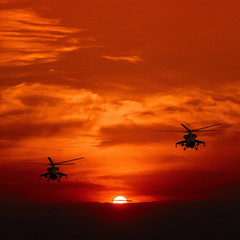 Fototapeta na wymiar Combat helicopter against warm sunset