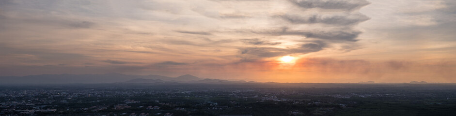 Beautiful clouds in the sky with light through the clouds over the city.Panorama